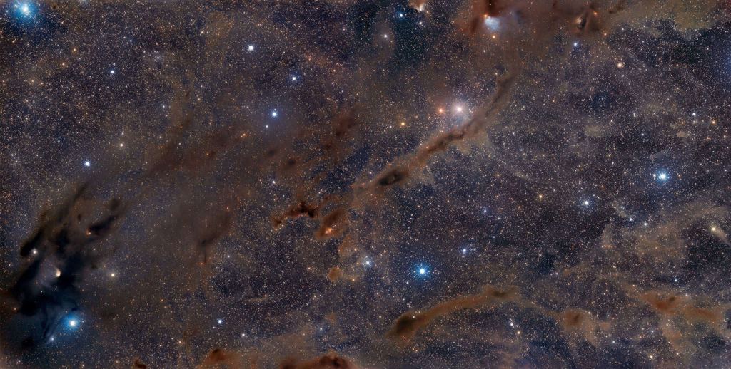 This is a two-panel mosaic of part of the Taurus Giant Molecular Cloud, the active star-forming region closest to Earth.  The darkest regions are where stars are born.  The research shows that small inhomogeneities in the cloud can produce binary stars with different metallicities.  Image credit: Adam Block/Steward Observatory/University of Arizona